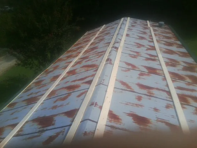 Rusted metal roof panels with new wood purlins before replacement — Storm Damage Roof Repair in Cedartown by Roofing Brothers