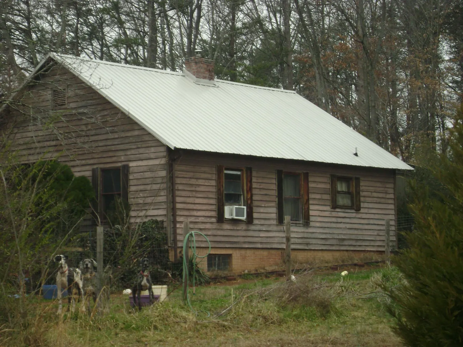 White metal roof on an old wood sided farmhouse, from a Metal Roof Installation job in Cedartown